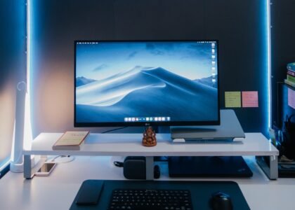 Computer monitor and keyboard on a desk representing digital creation for NFTs