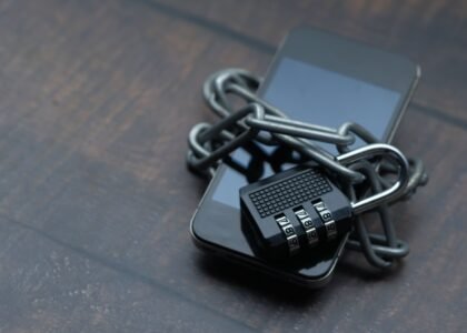 Smartphone secured with a chain and padlock symbolizing how to protect your crypto seed phrase