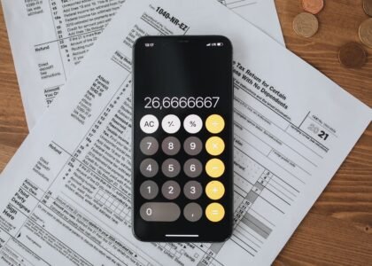 Tax documents and calculator representing how crypto is taxed in the UK