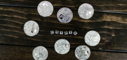 Silver cryptocurrency coins on a wooden surface representing Litecoin and crypto investing in the UK