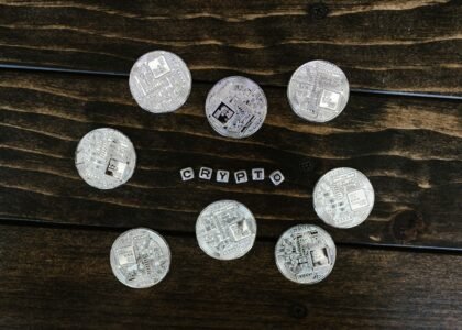 Silver cryptocurrency coins on a wooden surface representing Litecoin and crypto investing in the UK