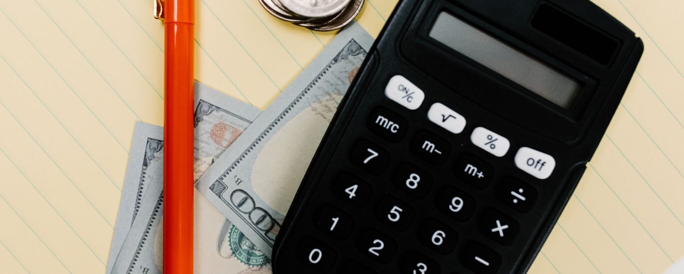Calculator and coins symbolizing how to calculate crypto gas fees