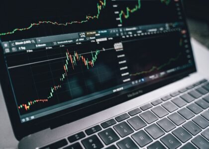 Laptop displaying a stock market trading chart