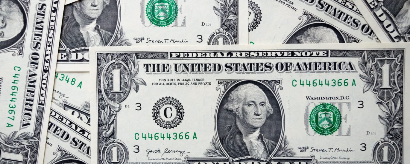 Stack of US dollar bills symbolizing stablecoin dollar peg