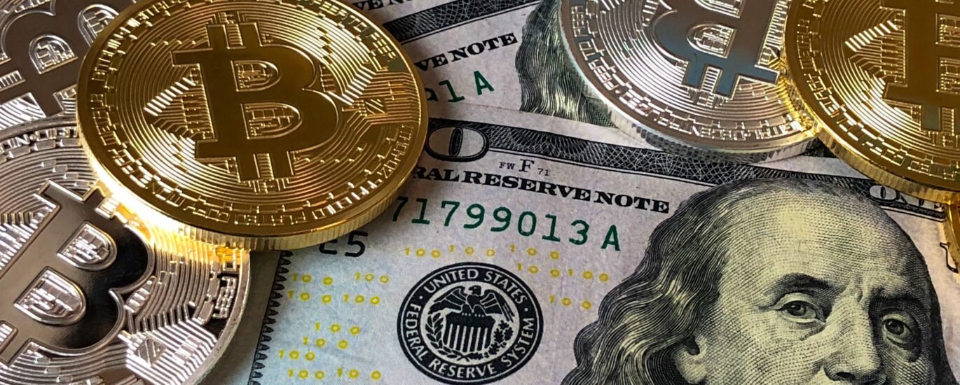 Bitcoin coins placed on US dollar bills representing decentralized finance